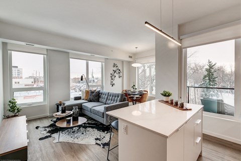 a living room with a couch and a kitchen